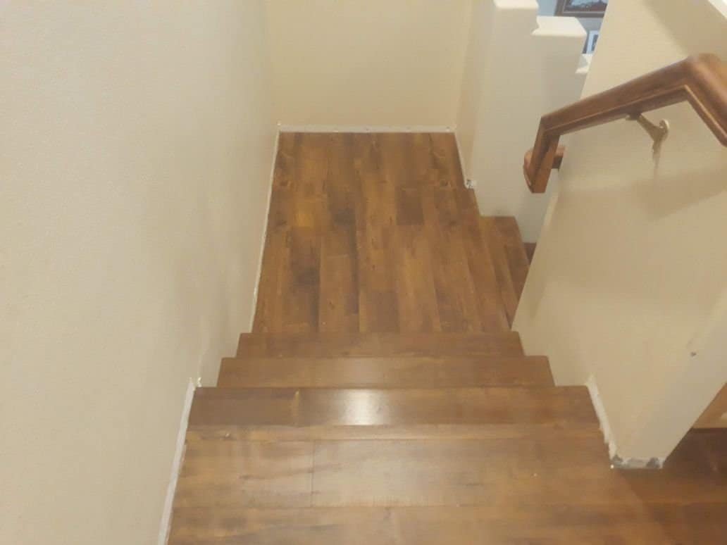 Wooden staircase with hardwood flooring installation by Ramos Carpet Installation Inc.