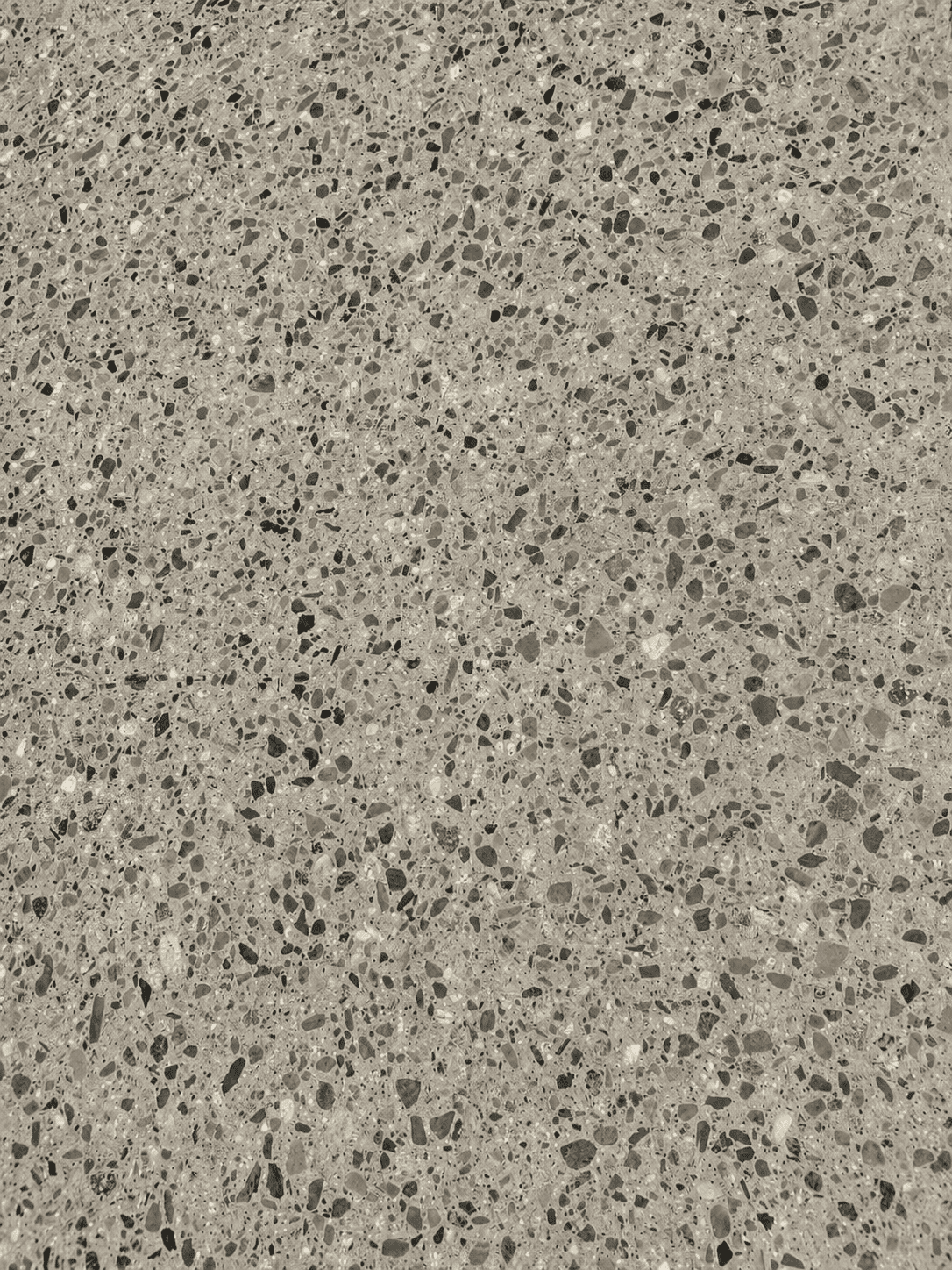 Close-up of a textured concrete floor with small aggregate stones.