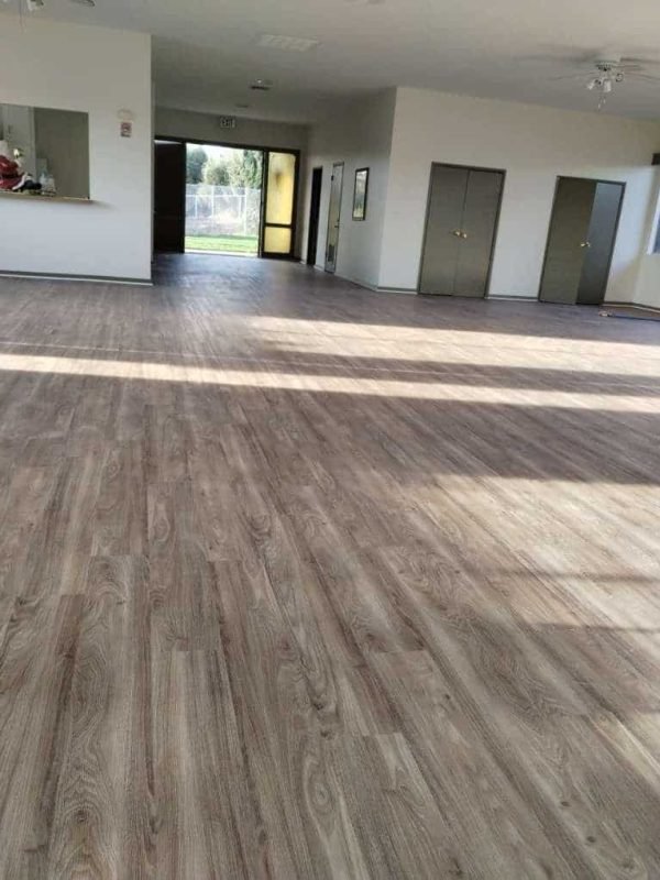 Luxury vinyl plank flooring installed in a modern interior space, great for homes and commercial areas.