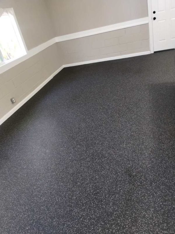 Smooth black and gray speckled commercial carpet in a modern interior room.